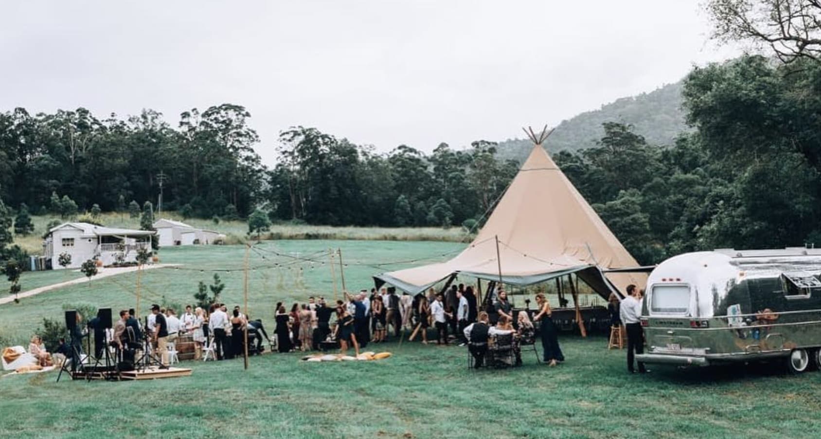 The Airstream parked in the Byron hinterland with a tipi behind
