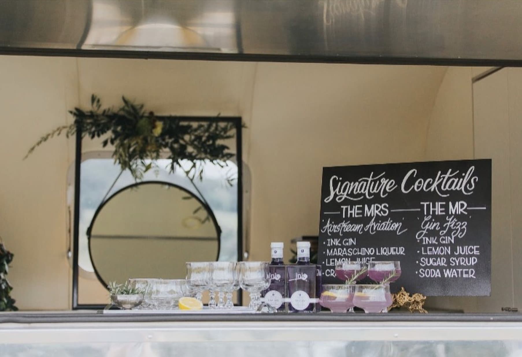Ink Gin Signature Cocktails activation, polished interior bar with chalkboard menu, mirror, greenery and lavender cocktails
