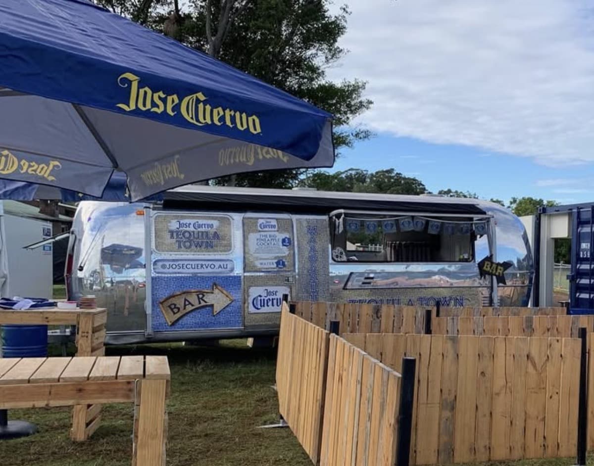Jose Cuervo Tequila Town activation, the Airstream styled as the festival bar with branded umbrella and signage